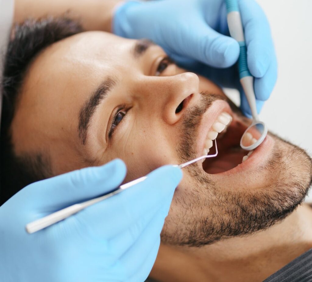 smiling-young-man-sitting-